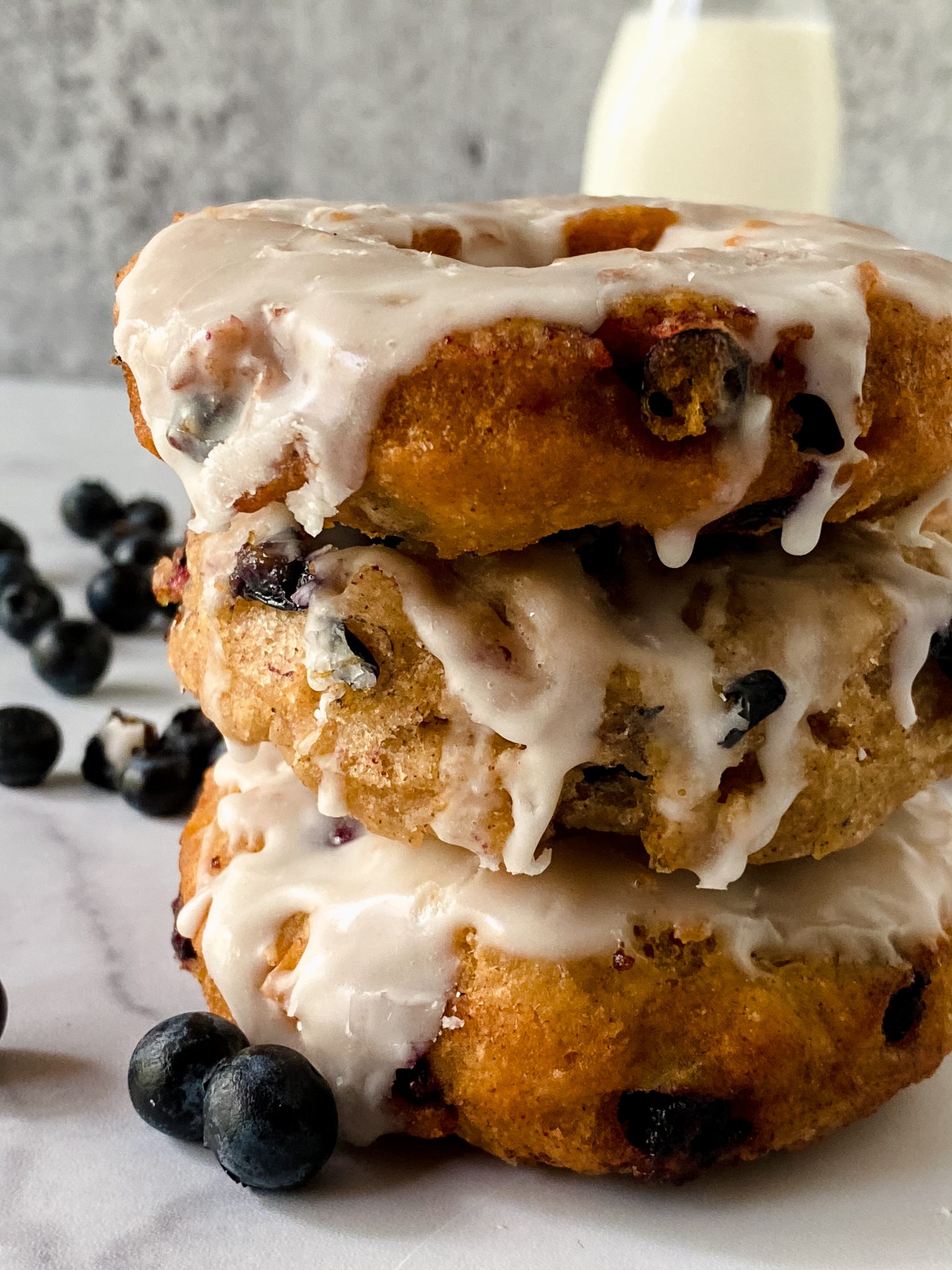 stack of glazed blueberry donuts with close-up.