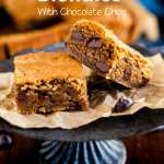 Front view of two peanut butter chocolate chip cookie bars sitting on a pedestal