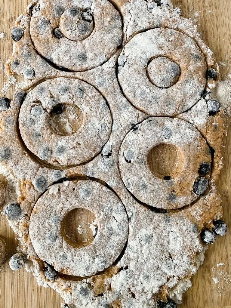 Donut shapes stamped out of dough.