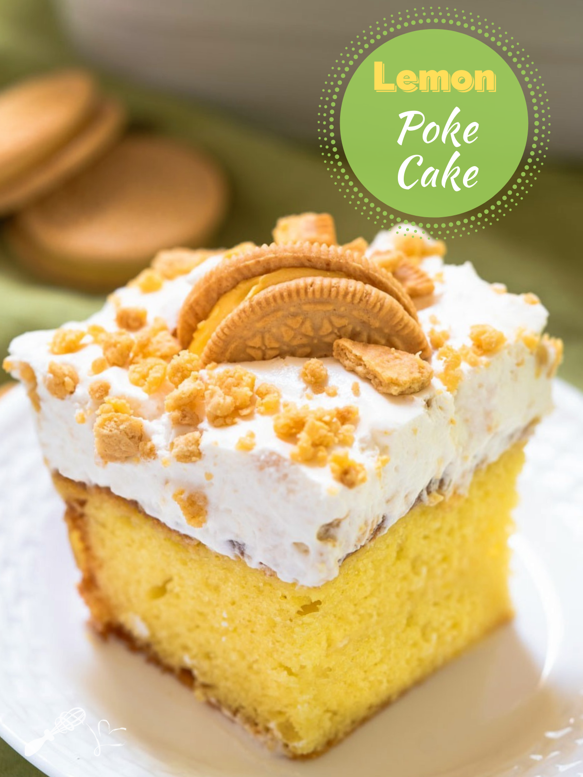 3/4 view of a slice of lemon cake topped with whipped topped and crumbled cookies