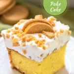 3/4 view of a slice of lemon cake topped with whipped topped and crumbled cookies