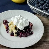 3/4 angled view of a serving of lemon blueberry dump cake on a plate.