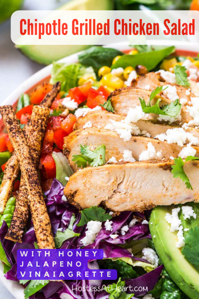 3/4 angle of a salad topped with sliced chicken, corn, red cabbage, Cotija, avocado and tortilla straws.