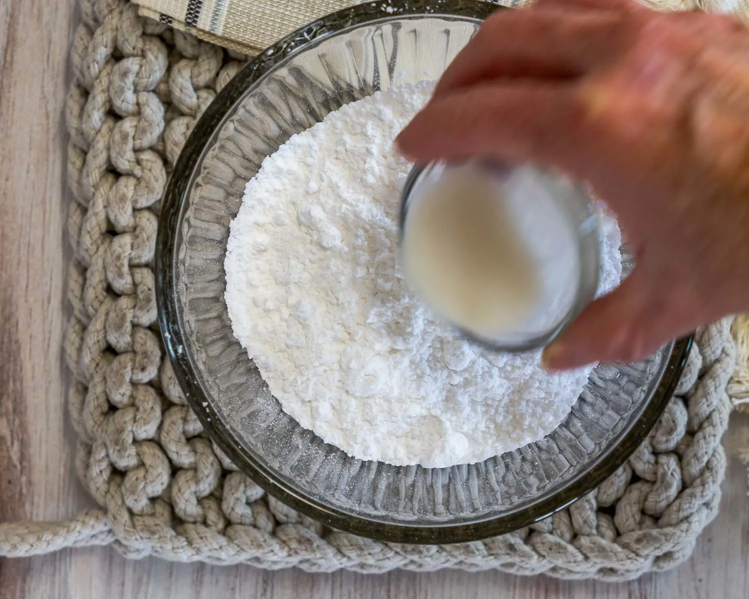 Milk being added to powdered sugar.