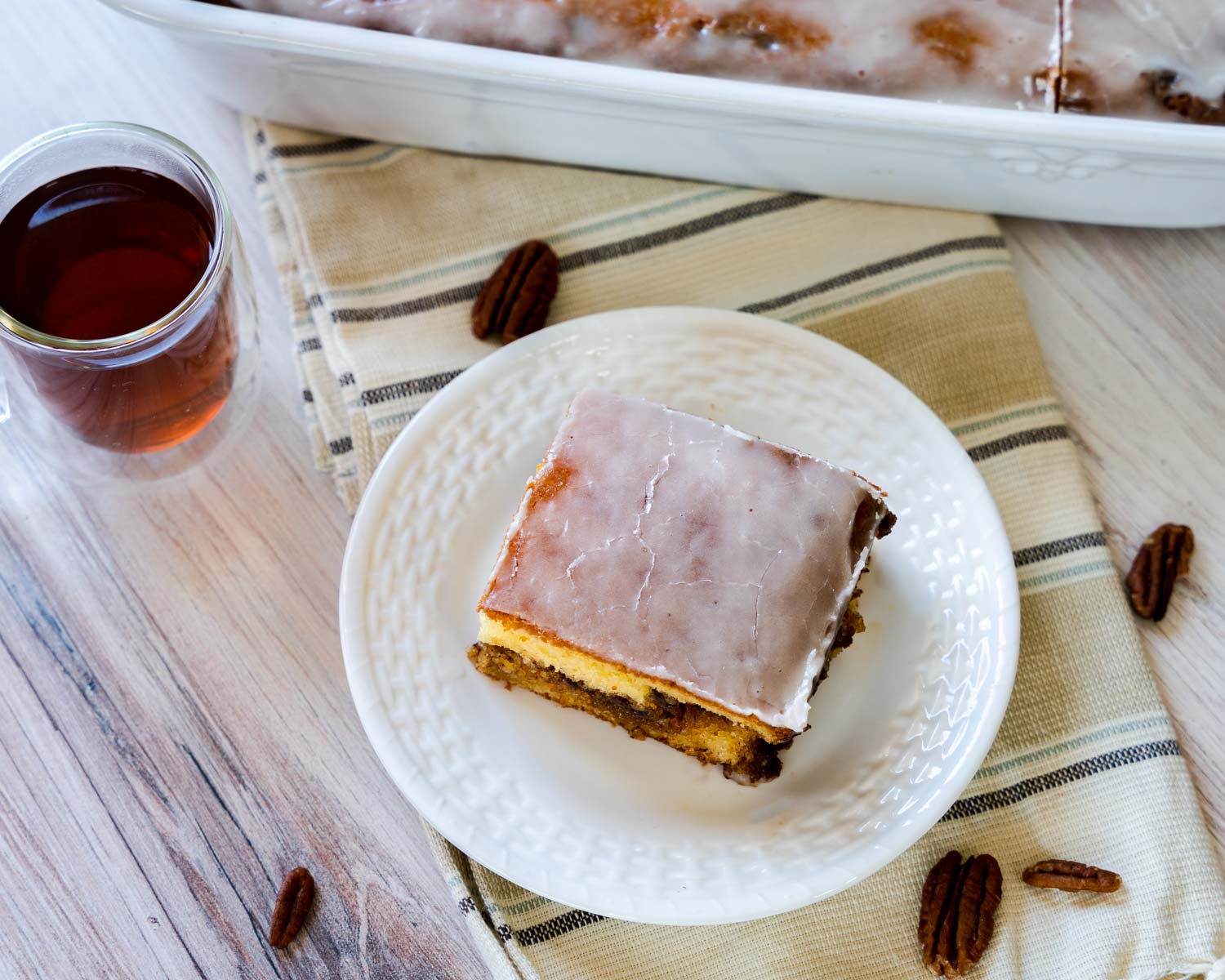Top down view of a piece of glazed honey bun cake.