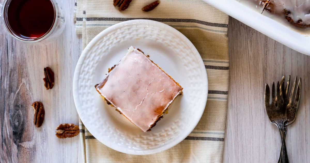 Top down view of a piece of glazed honey bun cake.