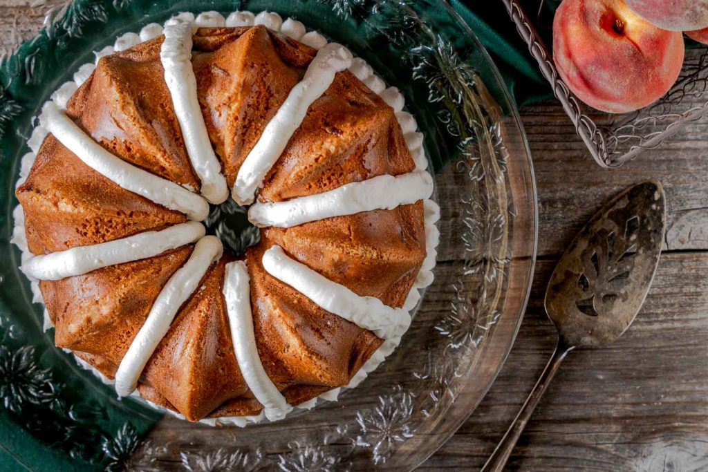 Top down view of Beautiful peach Bundt Cake on a platter. 