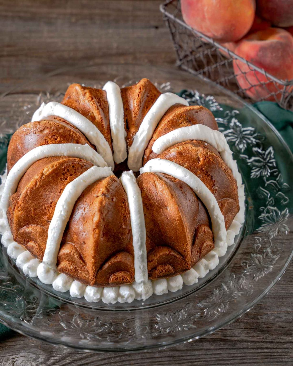 Angled view of gorgeous Peach  Cake with vanilla bean frosting.