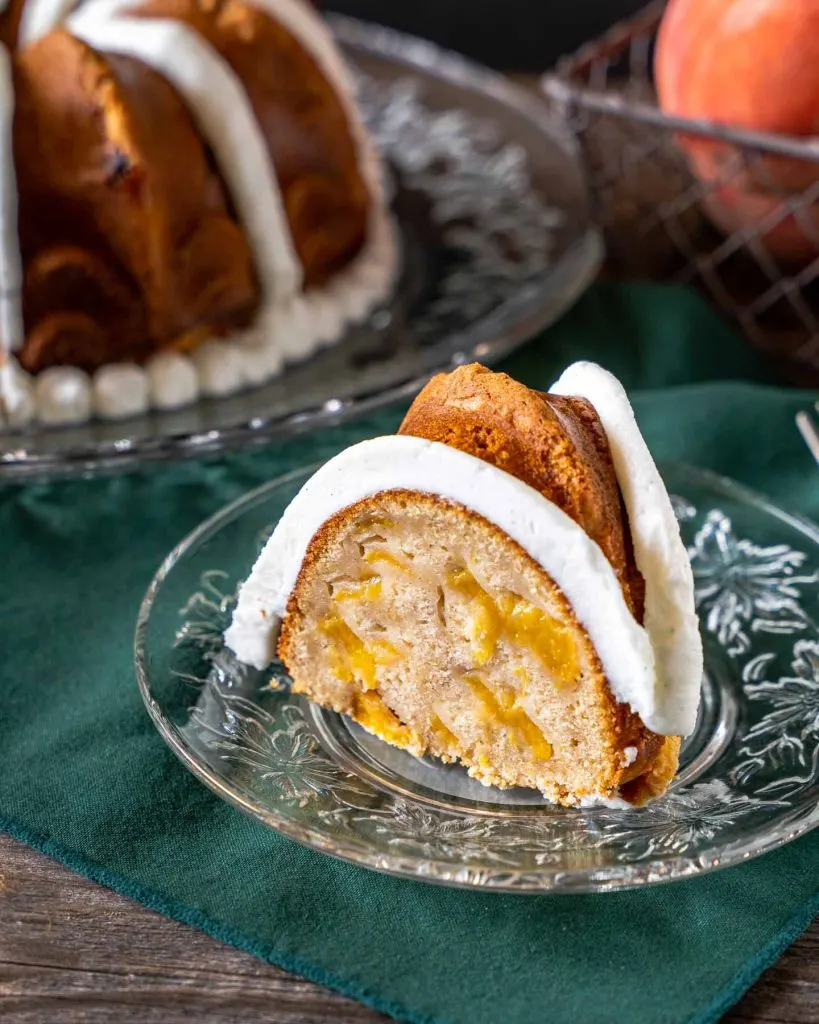 Single slice of peach cake on a plate.