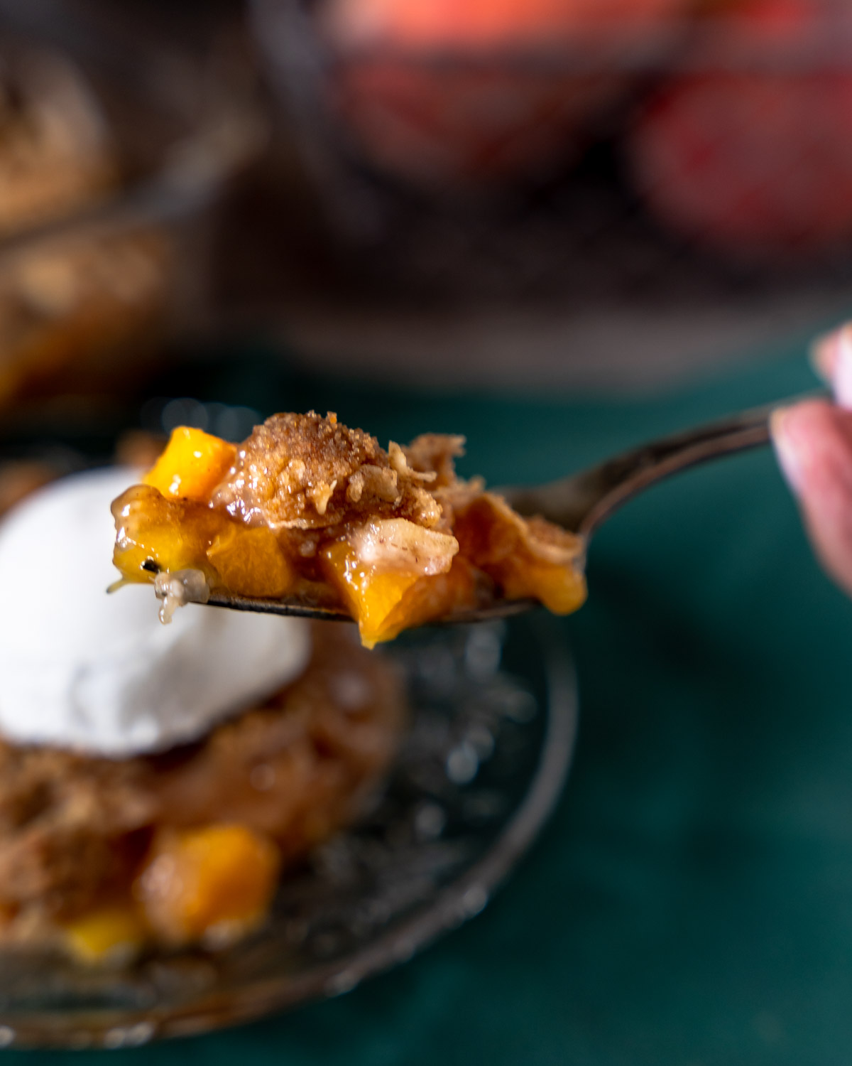 close up of single bite of peach crumble with oats.