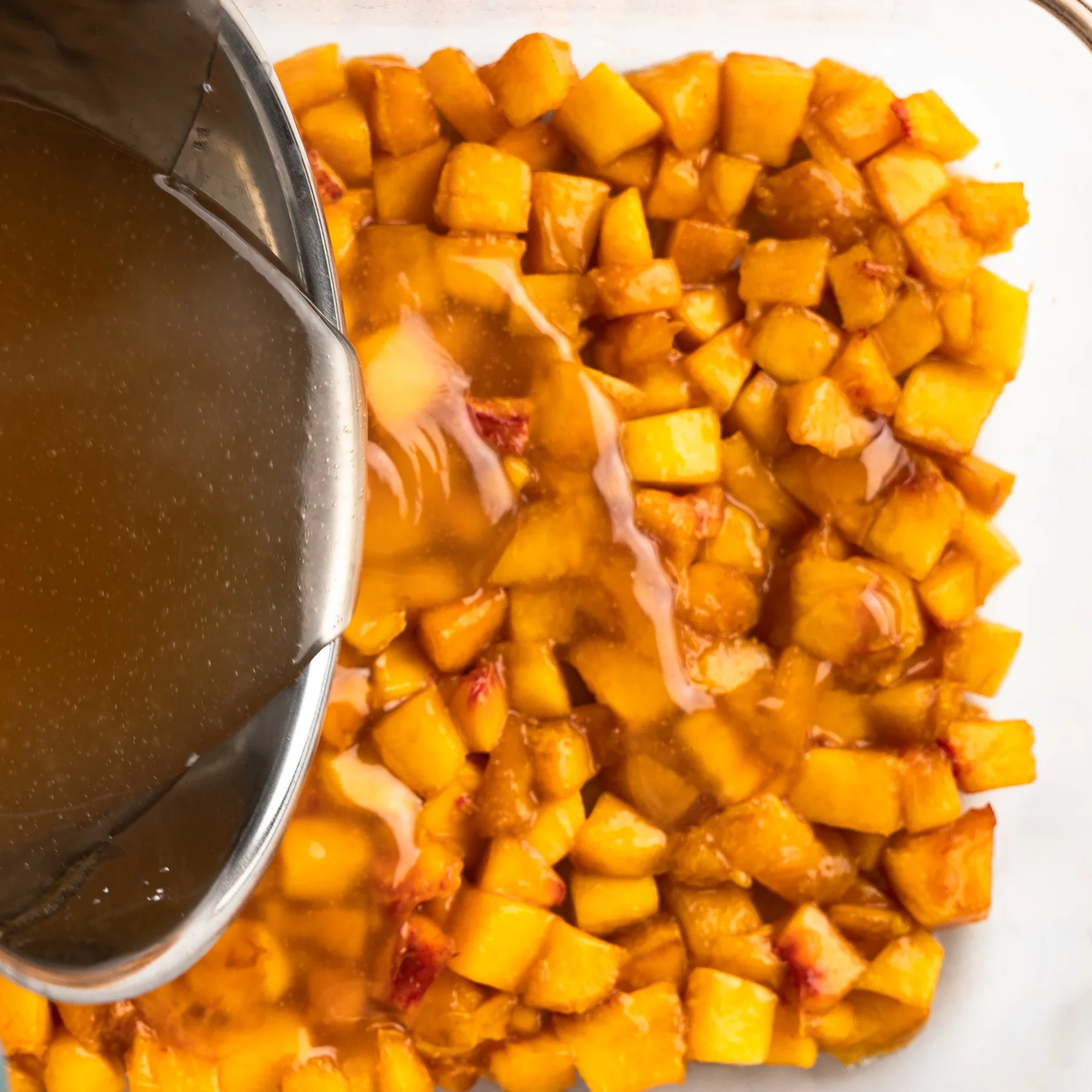 Filling mixture as it is poured over the peaches.