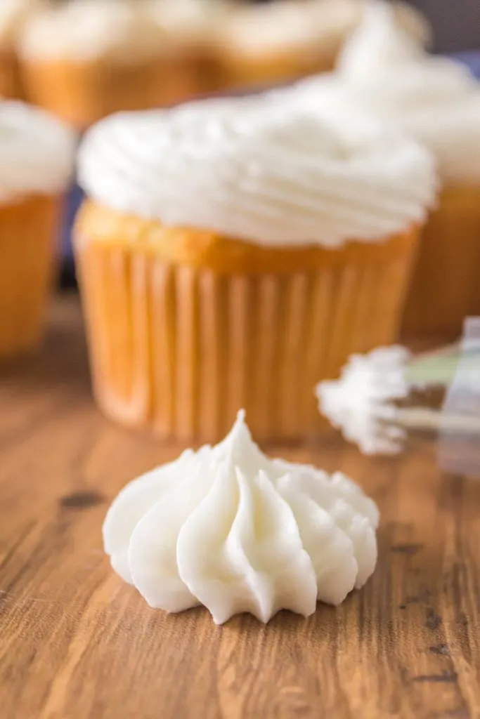 Piped vanilla frosting star on a counter.