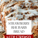 3/4 angle of strawberry rhubarb bread topped with streusel and a drizzle of glaze.