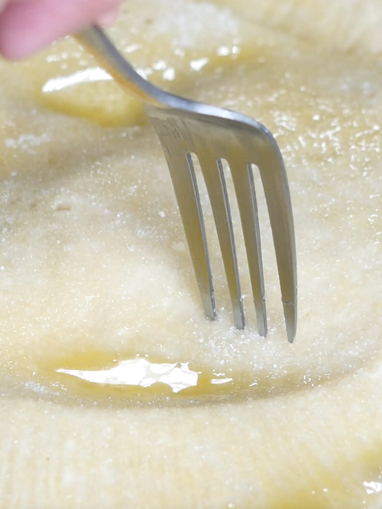 Fork piercing a pie crust