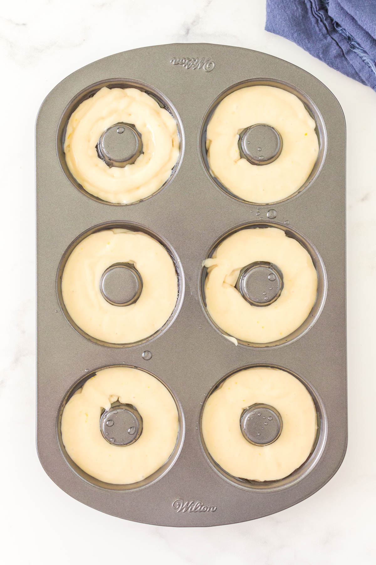 A donut pan filled with batter.
