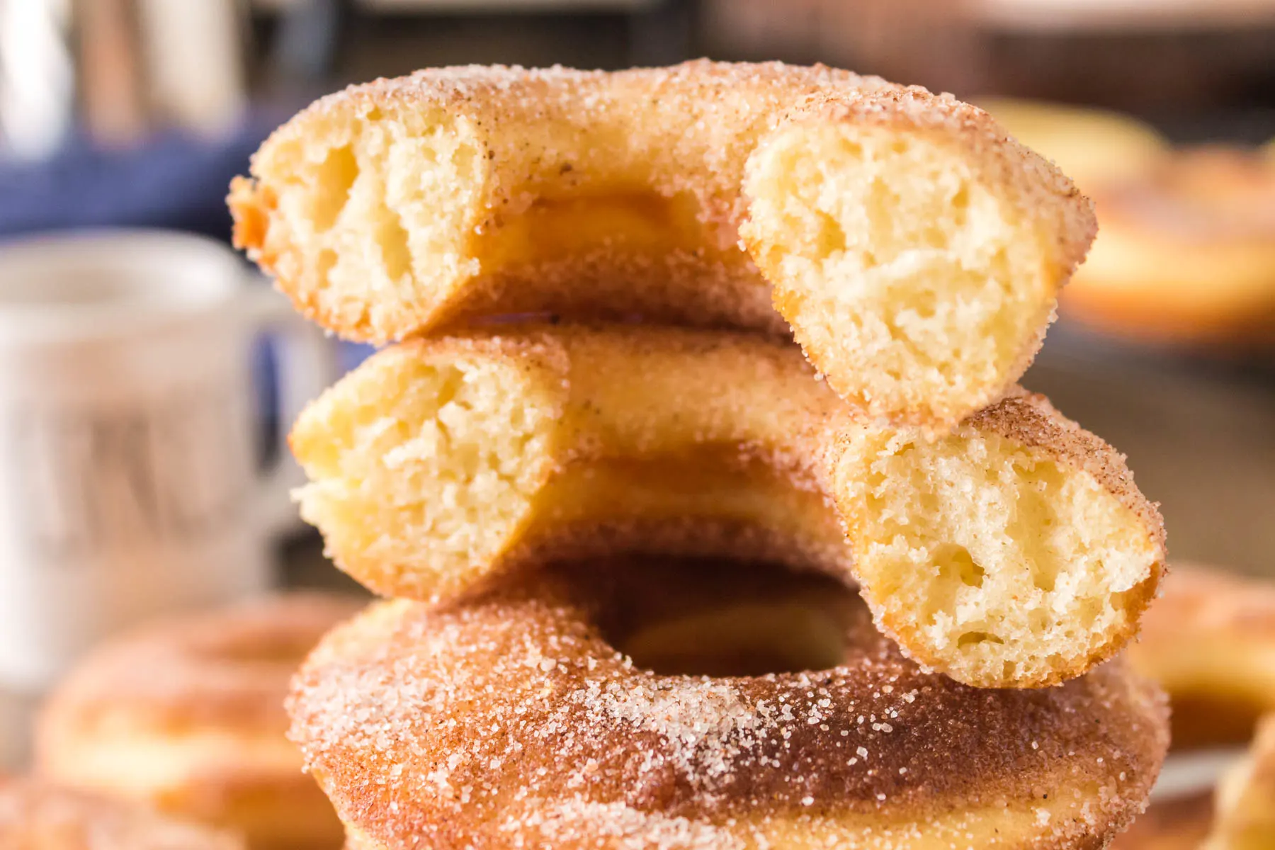 Split open sourdough donuts on a plate, close-up view.