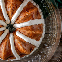 Top down view of a Fresh Peach Bundt Cake Recipe piped with frosting.