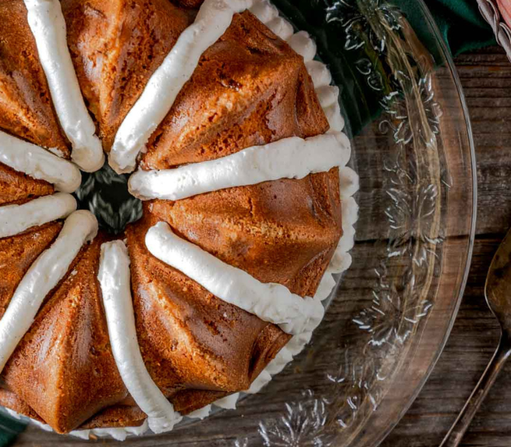 Top down view of a Fresh Peach Bundt Cake Recipe piped with frosting.