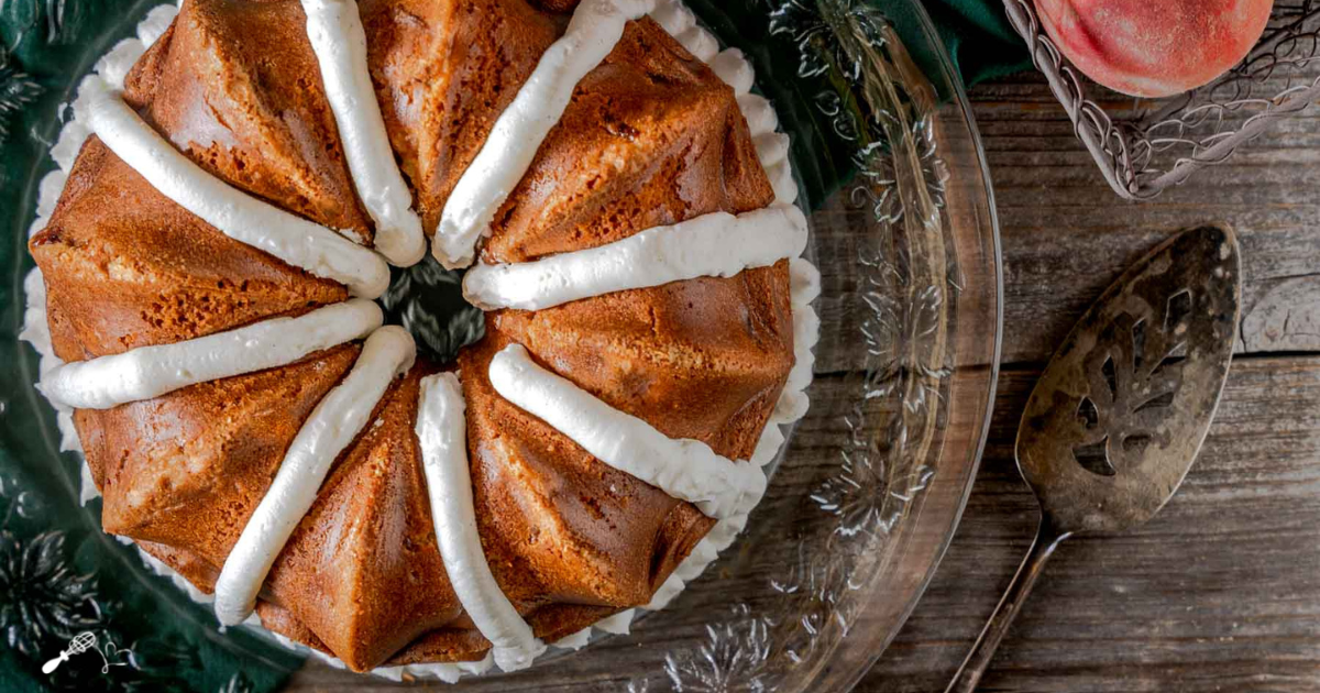 Top down view of a Fresh Peach Bundt Cake Recipe piped with frosting.