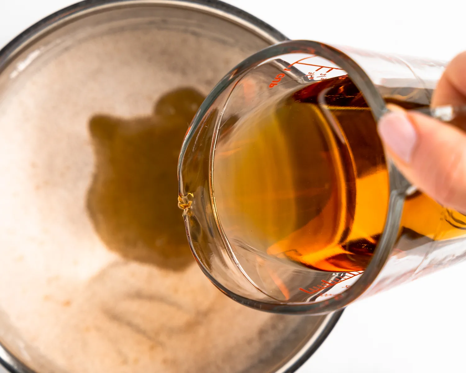 Bourbon poured into a pan to make peach bourbon sauce