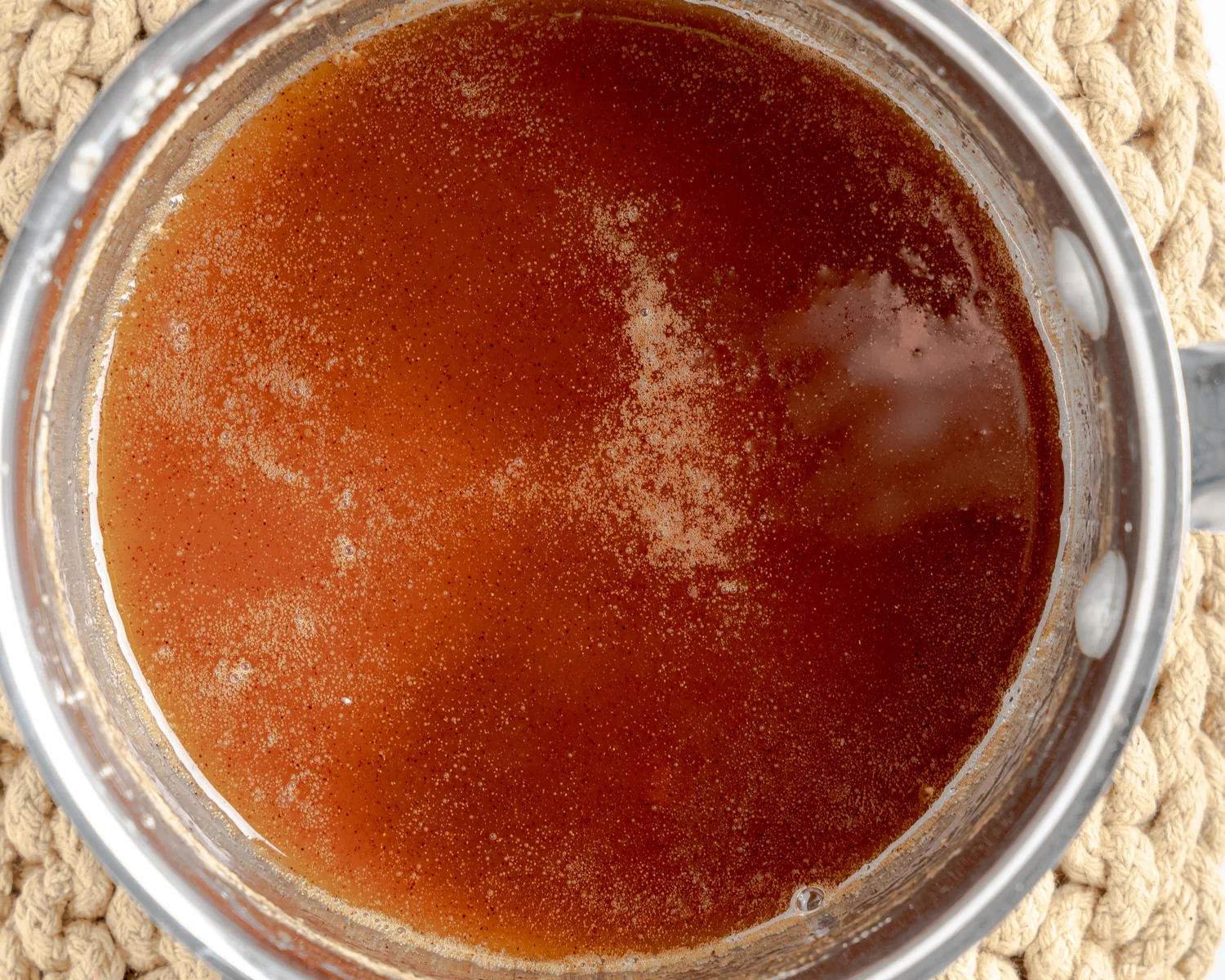 A pan of simmering bourbon sauce