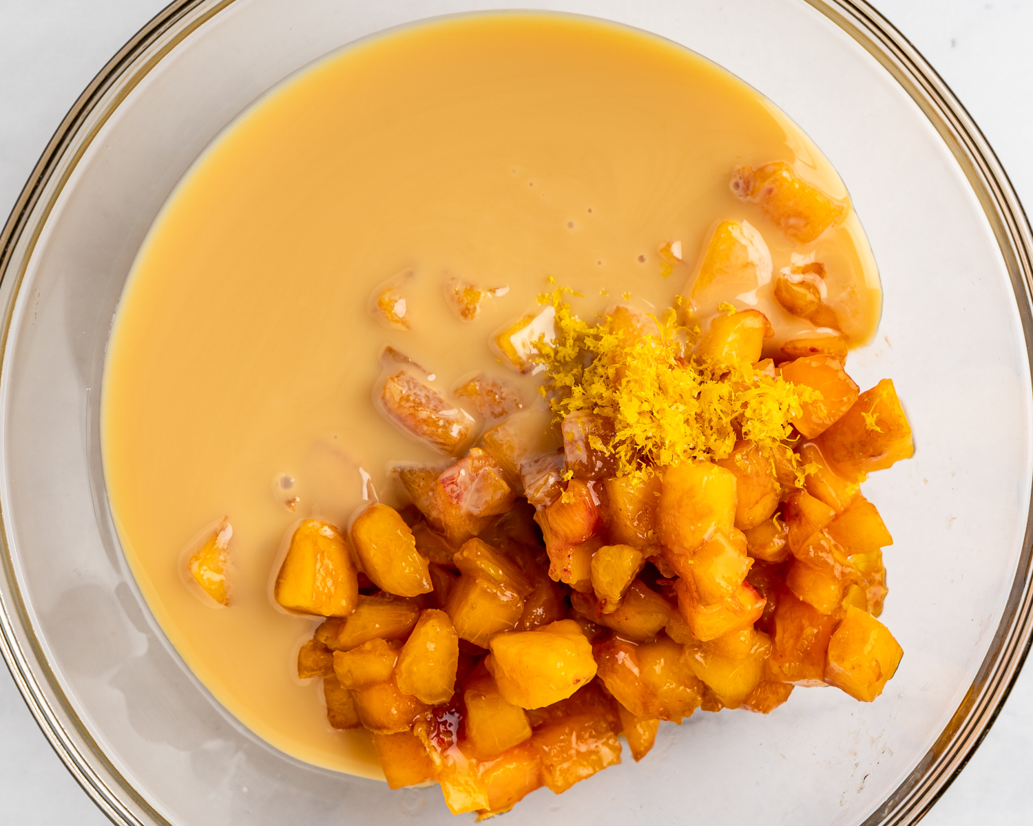 Sweetened condensed mil mixed with fresh peaches and lemon juice.