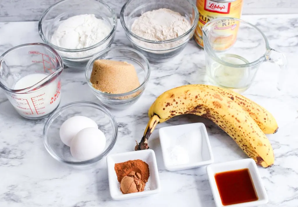 Ingredients: Bananas, flour, sugar, whole wheat flour, milk, eggs, oil, cinnamon, pumpkin pie spice, brown sugar, vanilla, pumpkin puree, salt, buttermilk, baking soda.