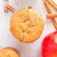 Top down view of a muffin with apple baked into it.