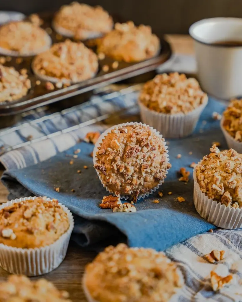 A muffin laying on it's side surrounded by upright muffins.