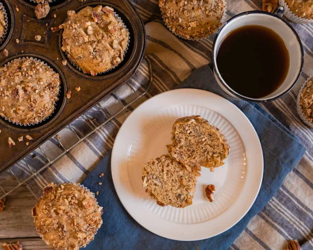 Top down view of a baked banana muffin cut in half showing nuts