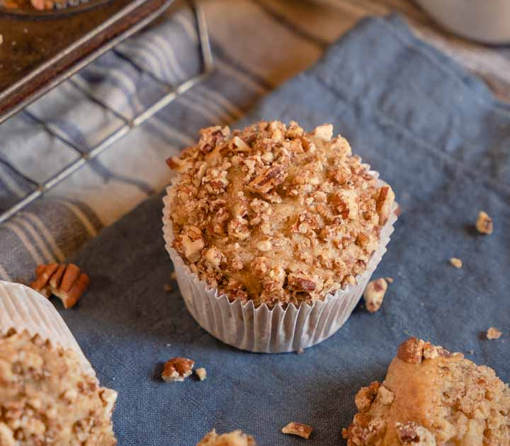 Top down view of a banana muffin topped with nuts