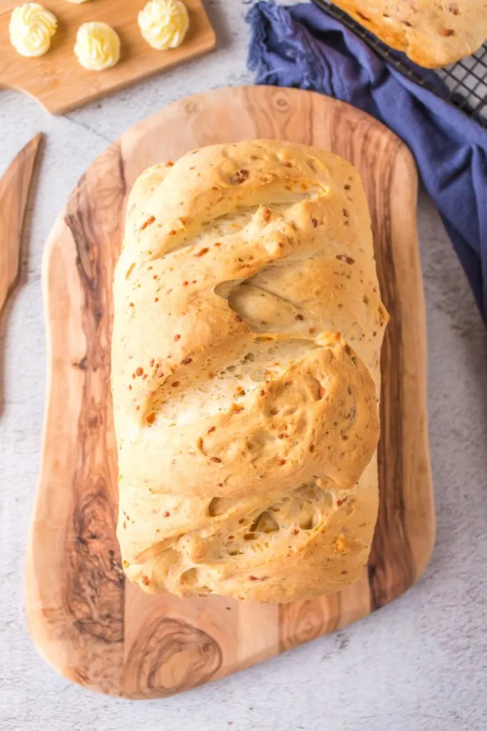 Loaf of cheddar bread is ready to slice.