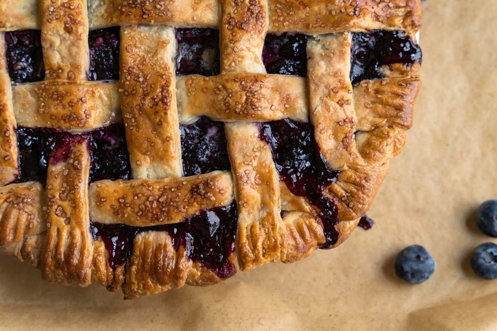 Close-up top down view of a homemade blueberry pie.