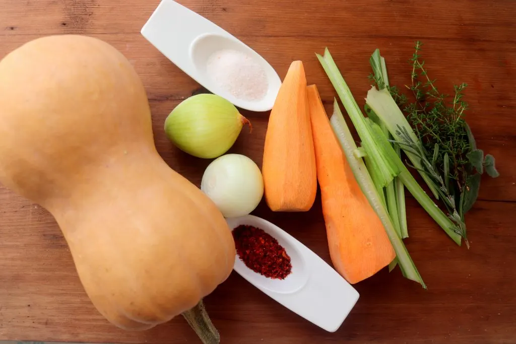 Top down view of the ingredients used to make butternut squash soup.
