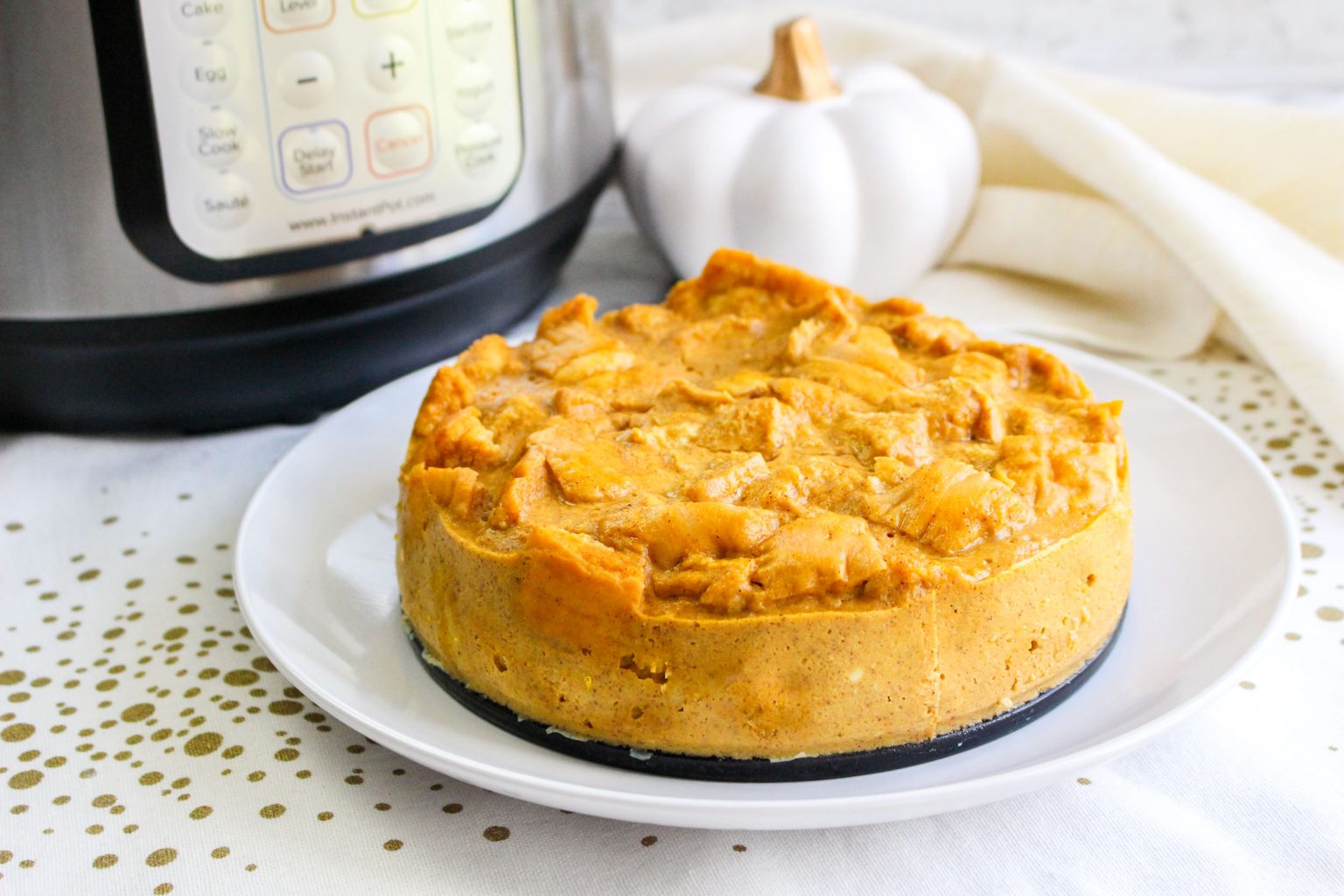 A pumpkin bread pudding dessert that's been removed from a springform pan - Hostess At Heart