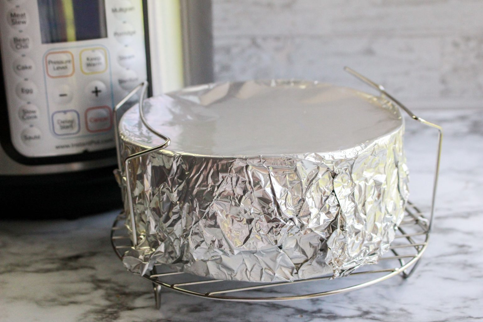 Springform pan wrapped in foil to prevent water seepage.