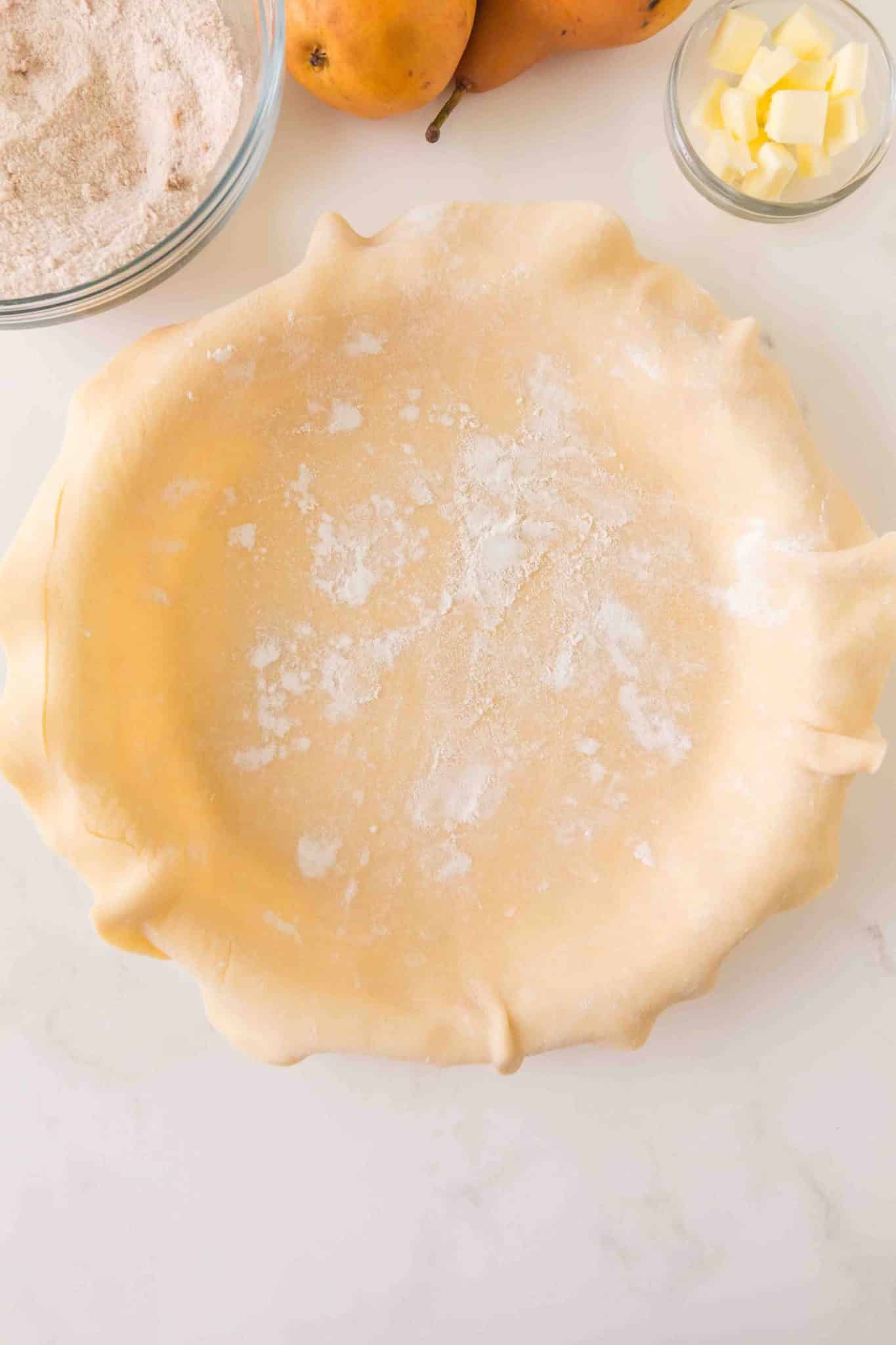 A pie plate topped with a an unbaked pie crust. Hostess At Heart