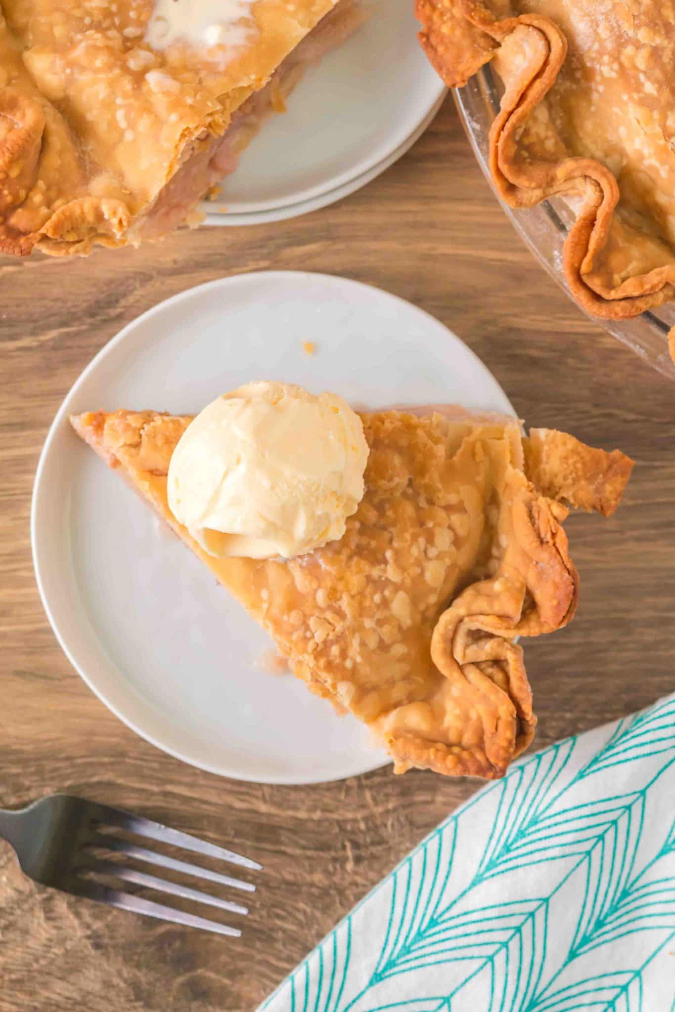 Top down view of a wedge of golden baked pie topped with vanilla ice cream - Hostess At Heart