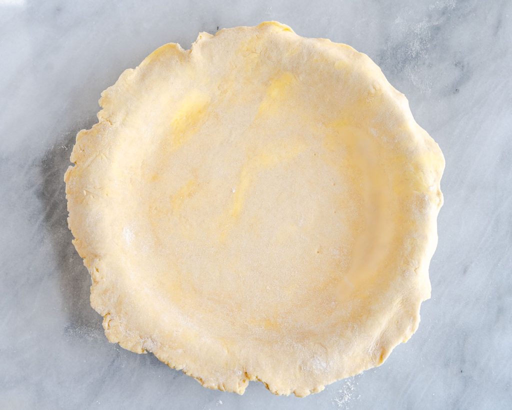 An all butter pie crust rolled into a pie plate.