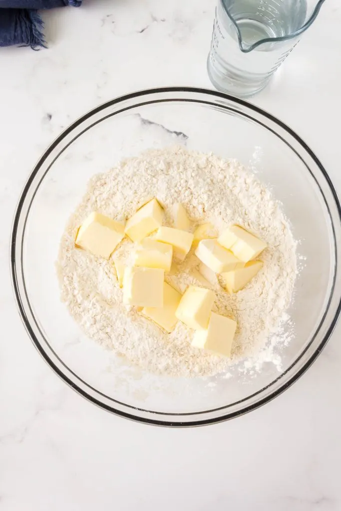 Chunks of butter in a bowl of flour used to make Pie crist.