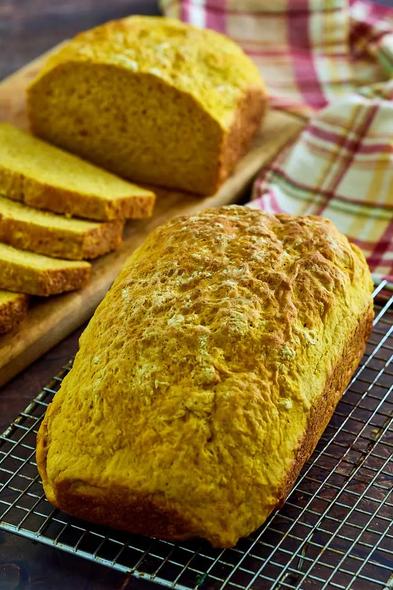 Uncut loaf of bread on a cooling rack