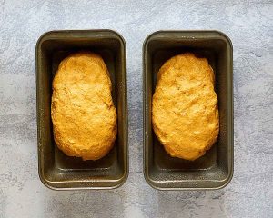 Two loaves of bread dough in loaf pans - Hostess At Heart