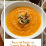 Top down view of a bowl of squash soup topped with pepitas.