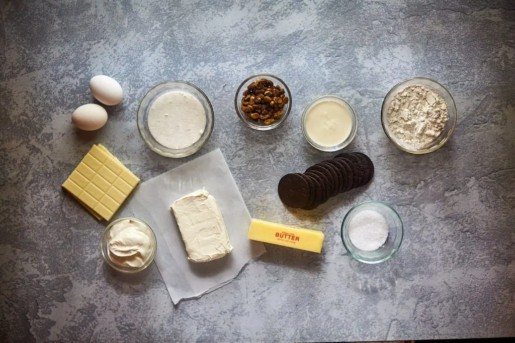 Ingredients: eggs, heavy cream, pistachios, sour cream, flour, white chocolate, cream cheese, butter, chocolate wafer cookies, salt, sugar.