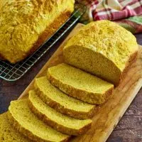 Angled view of a sliced loaf of soft pumpkin loaf bread