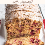 Front view of a loaf of sliced cranberry bread topped with streusel and glazed.