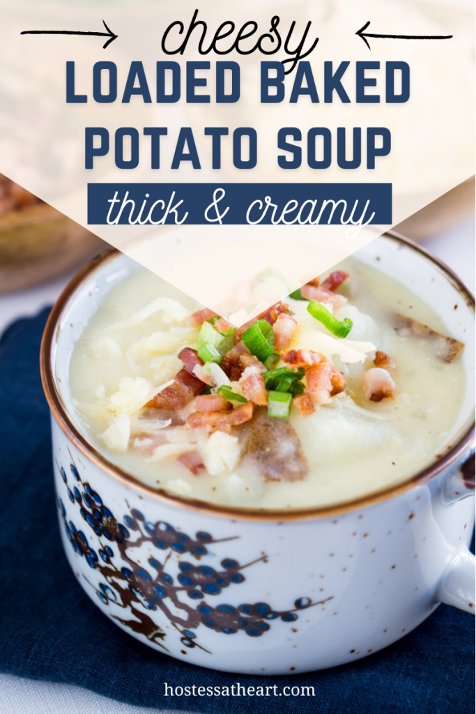 Side view of a bowl of thick cheese soup with potatoes, bacon and onion.