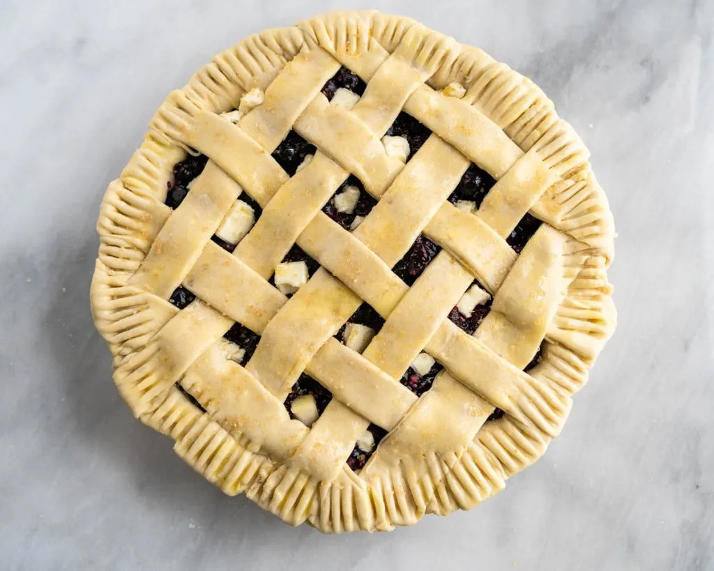 Top down view of an unbaked lattice topped pie.