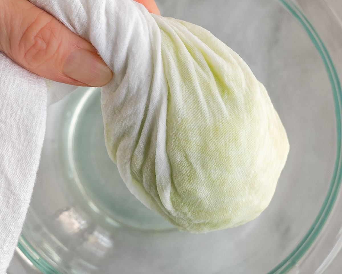 Grated apples twisted in a dish towel to remove the extra moisture.