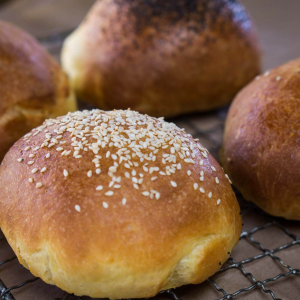 Side view of a bread bun topped with sesame seeds